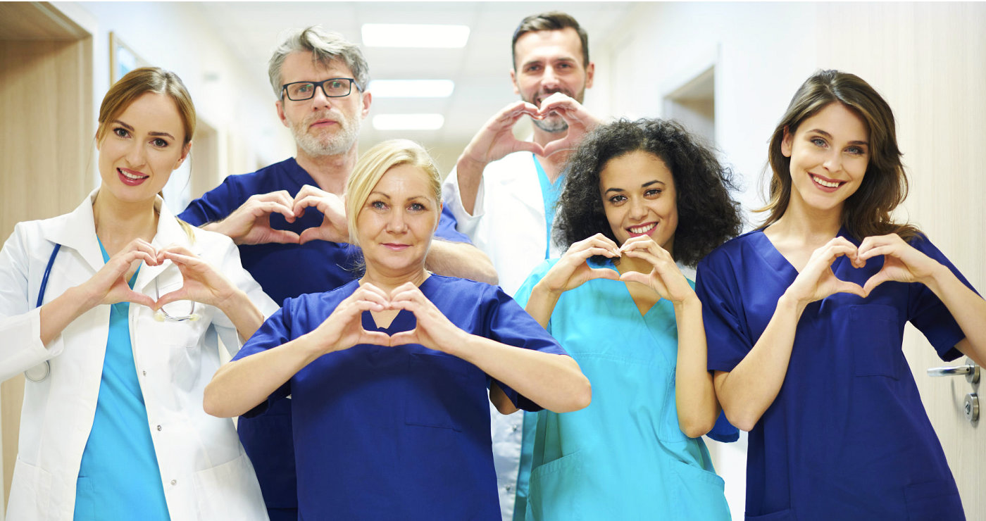 medical staff doing a heart sign